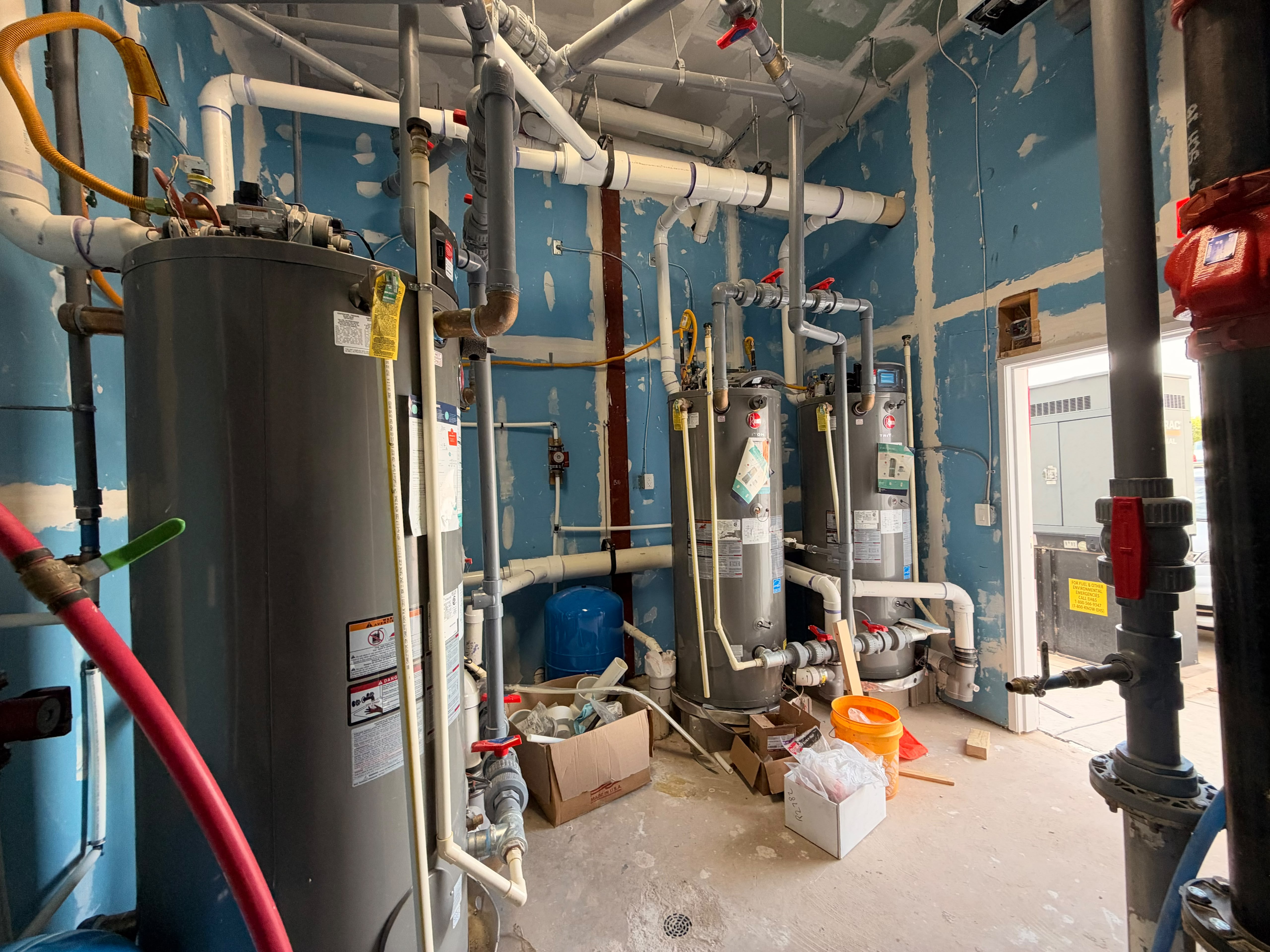 Mechanical room with commercial water heaters and process piping